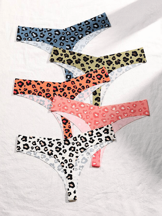 Colorful leopard print seamless T-back panties in various shades, laid in a stack. Perfect for stylish everyday comfort.